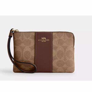 Coach corner zip wristlet in signature canvas with stripe